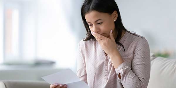 Woman looking at an unexpected bill